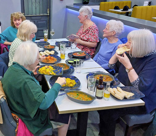 Ladies tuck into an Indian meal