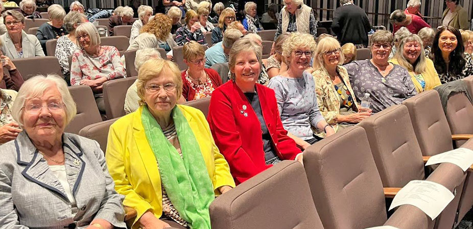 Eight ladies seated in the theatre