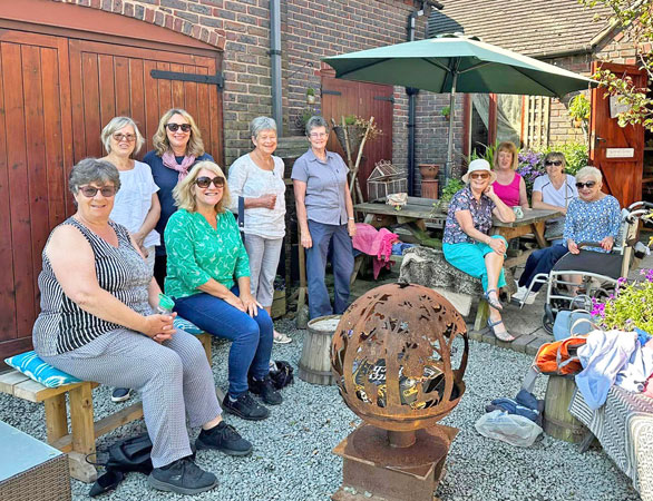 Several ladies sit in the sunshine