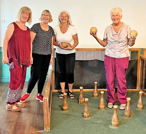 Four ladies pose with skittles before a game