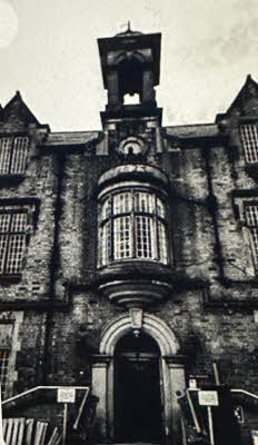 An old, black and white picture of the entrance to Shelton Hospital