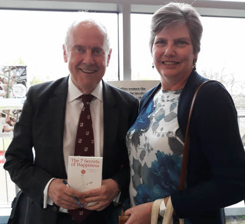 Giles Brandreth holding his book; our secretary, Cathy, standing beside him